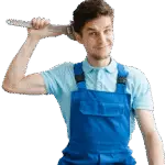 Young man in blue overalls with a wrench held to his head, smiling playfully.